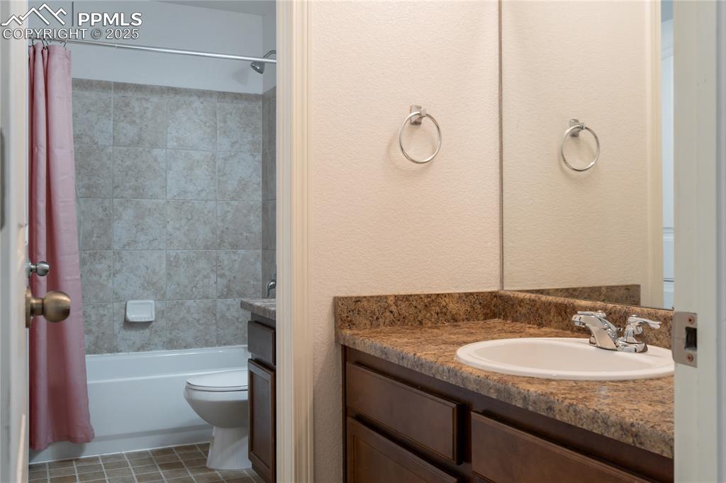Image 24 of 30: The perfect secondary bathroom with dual sinks and private space. 