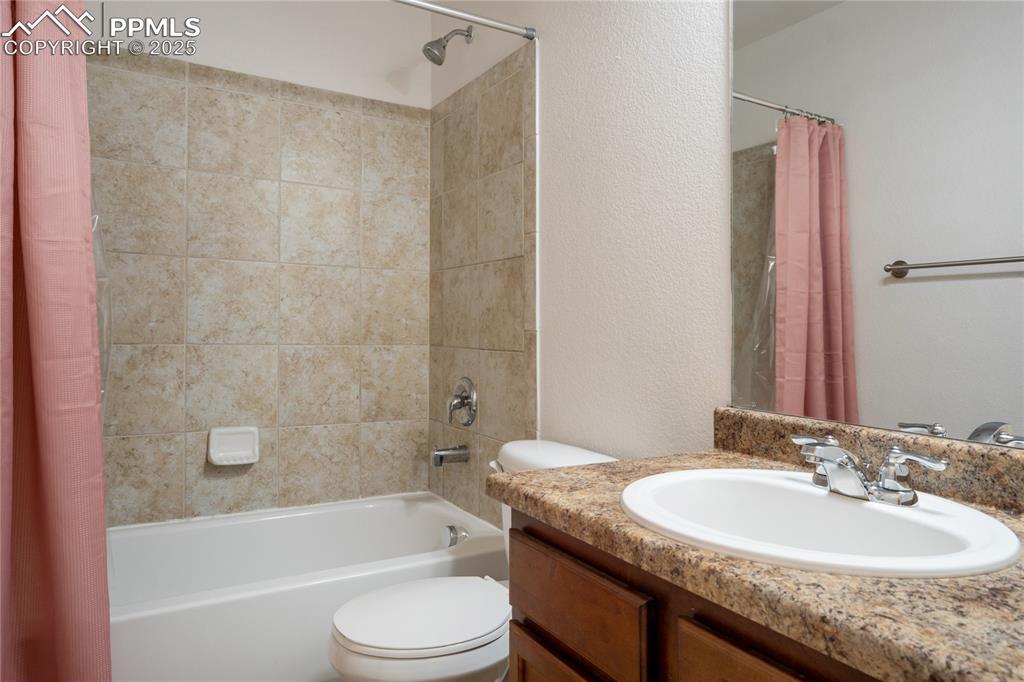 Image 25 of 30: The perfect secondary bathroom with dual sinks and private space