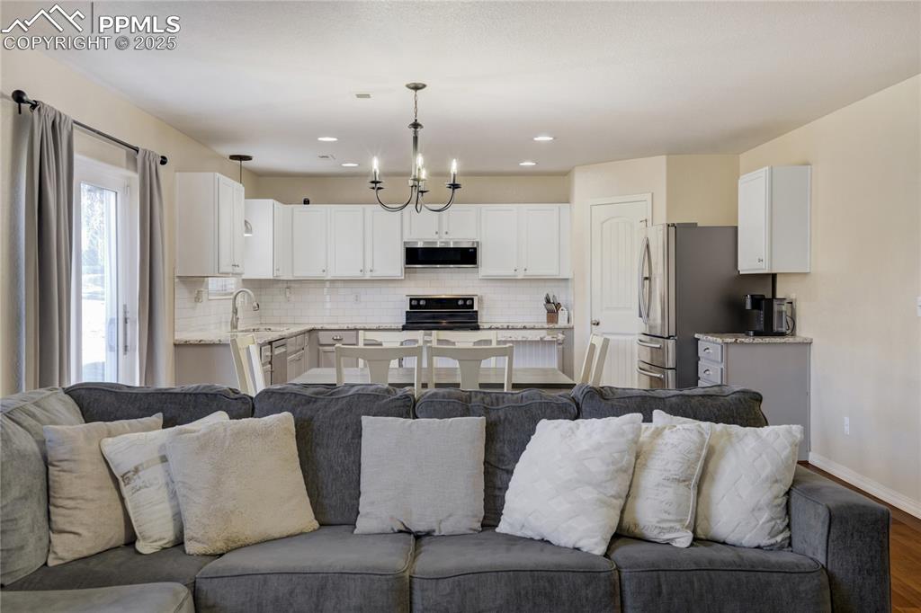Image 6 of 30: Open to the kitchen and dining room, this space is perfect for family gathe
