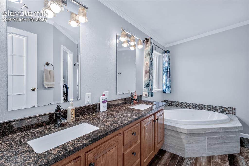 Image 15 of 45: Primary bath has spacious vanity with new granite counters and sinks, new v