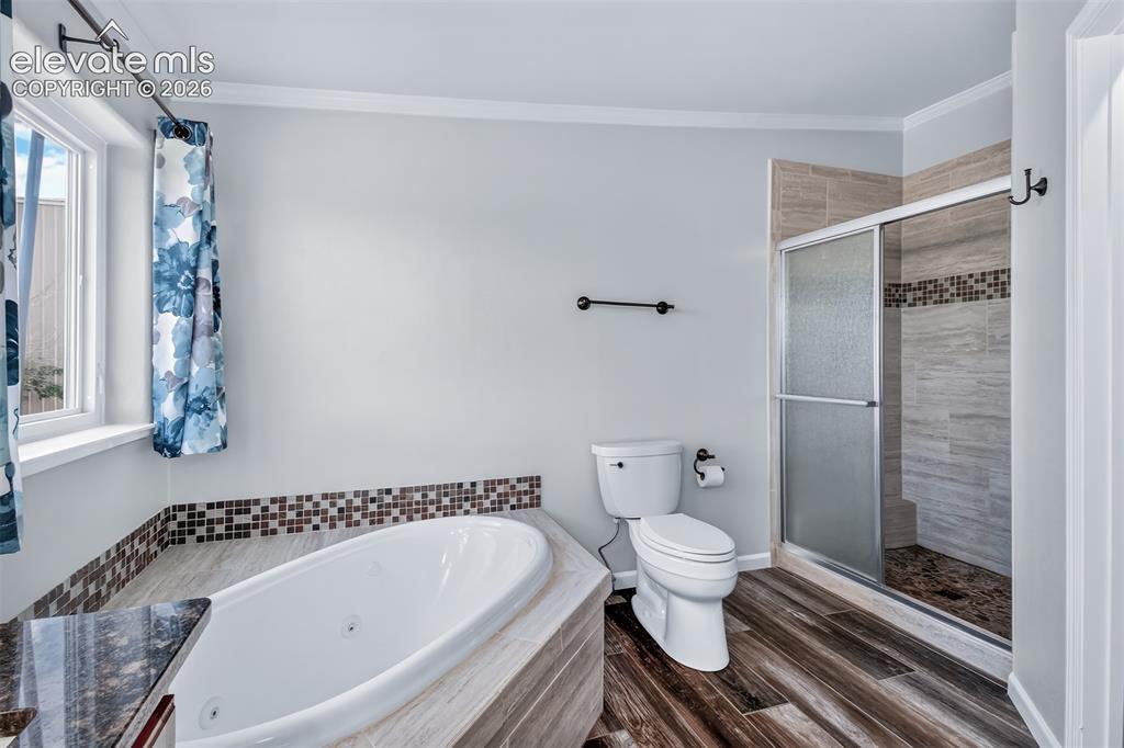 Image 16 of 45: Large shower with mud set pan and bench.
