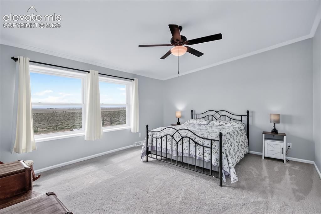 Image 18 of 45: Bedroom #2 is quite large, big viewing windows with views of the mountains