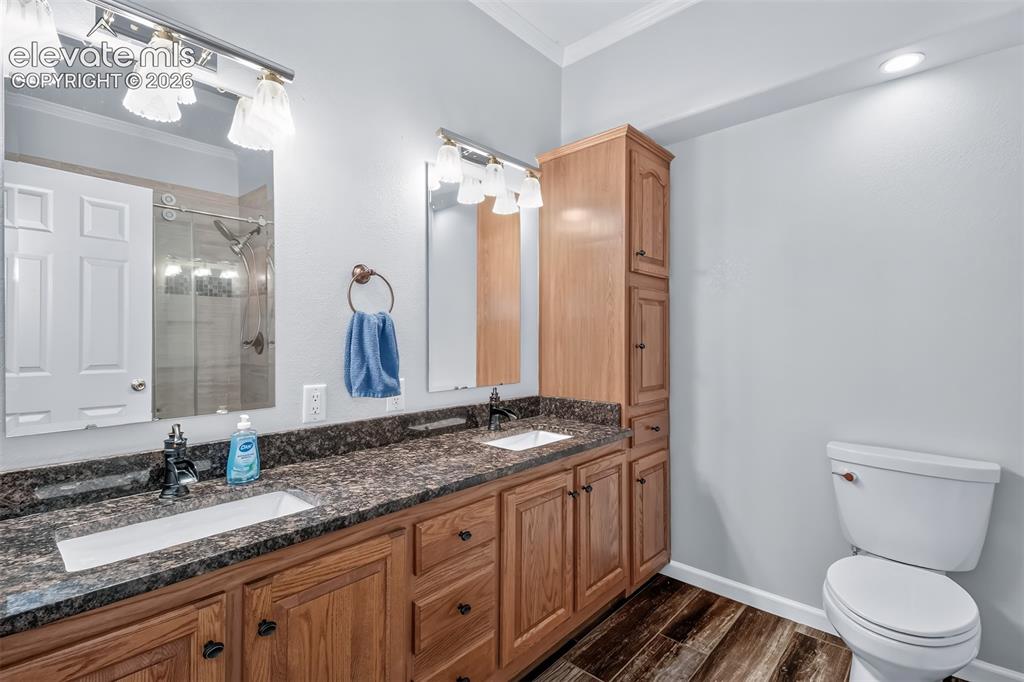 Image 22 of 45: Bathroom with double vanity, lots of cabinet space with large walk in showe