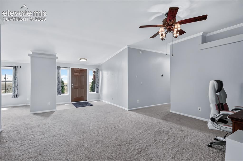 Image 6 of 45: Front door entrance with side lights leading to living room and dining area