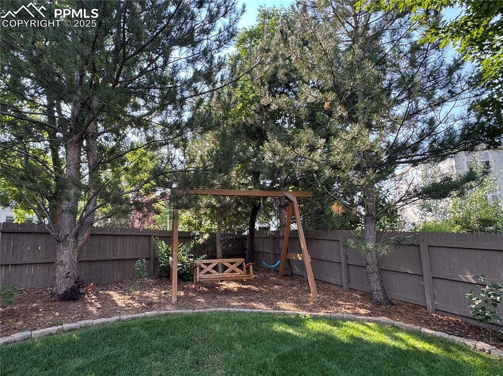 Image 28 of 35: View of fenced backyard
