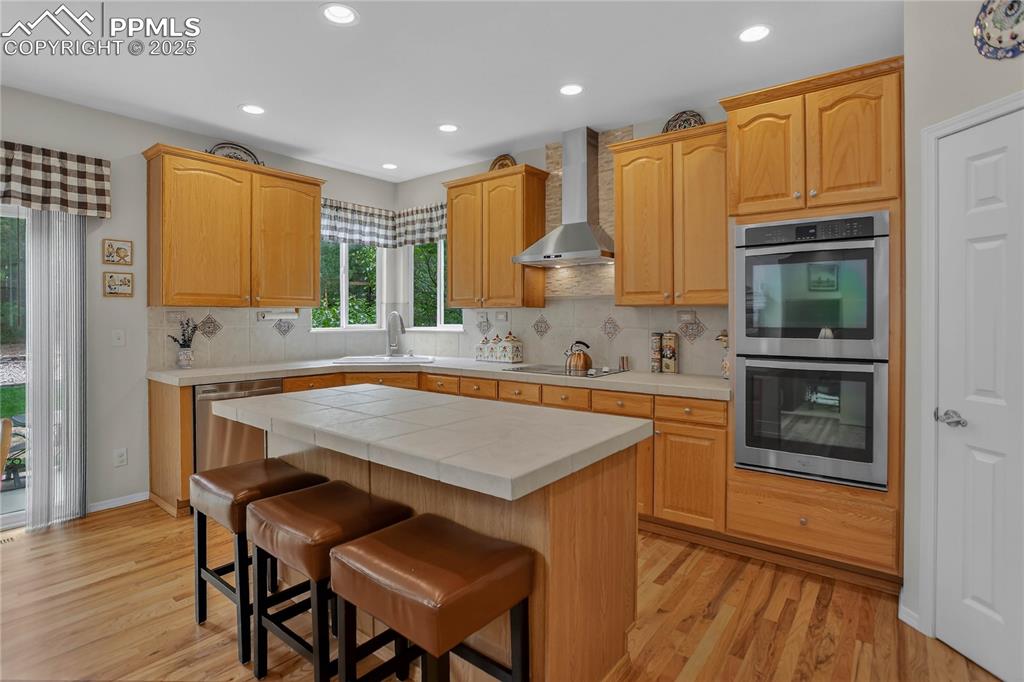 Image 8 of 35: Kitchen features 6-foot island w/ barstool seating
