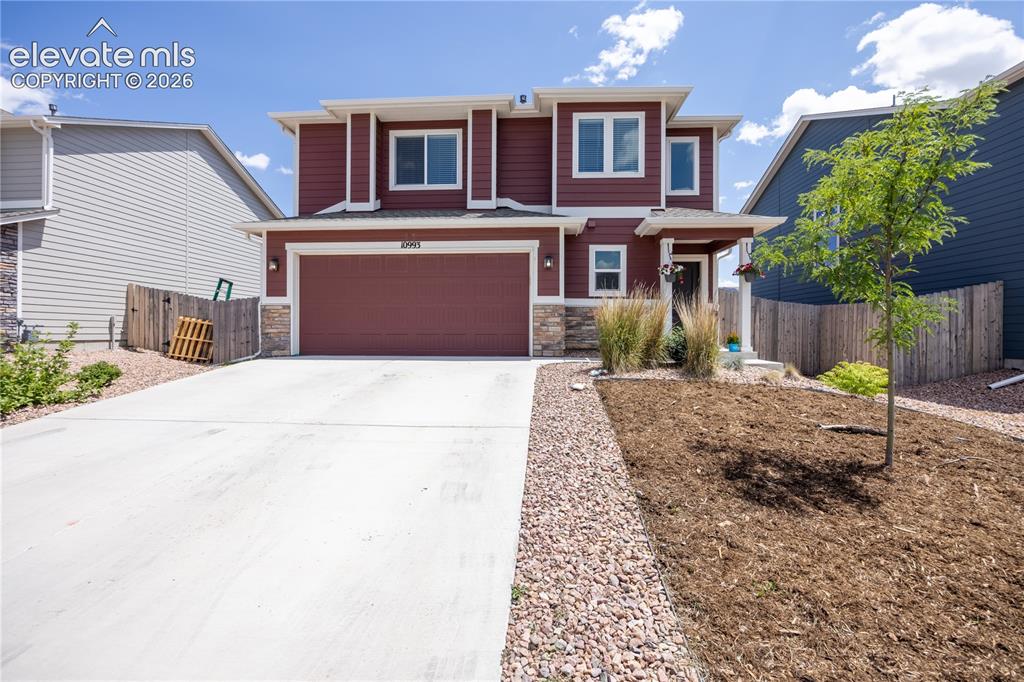 Image 1 of 42: Two-story home featuring a deep red siding exterior with white trim accents