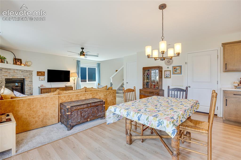 Image 14 of 42: Open-concept living area featuring light wood-finish flooring, a contempora