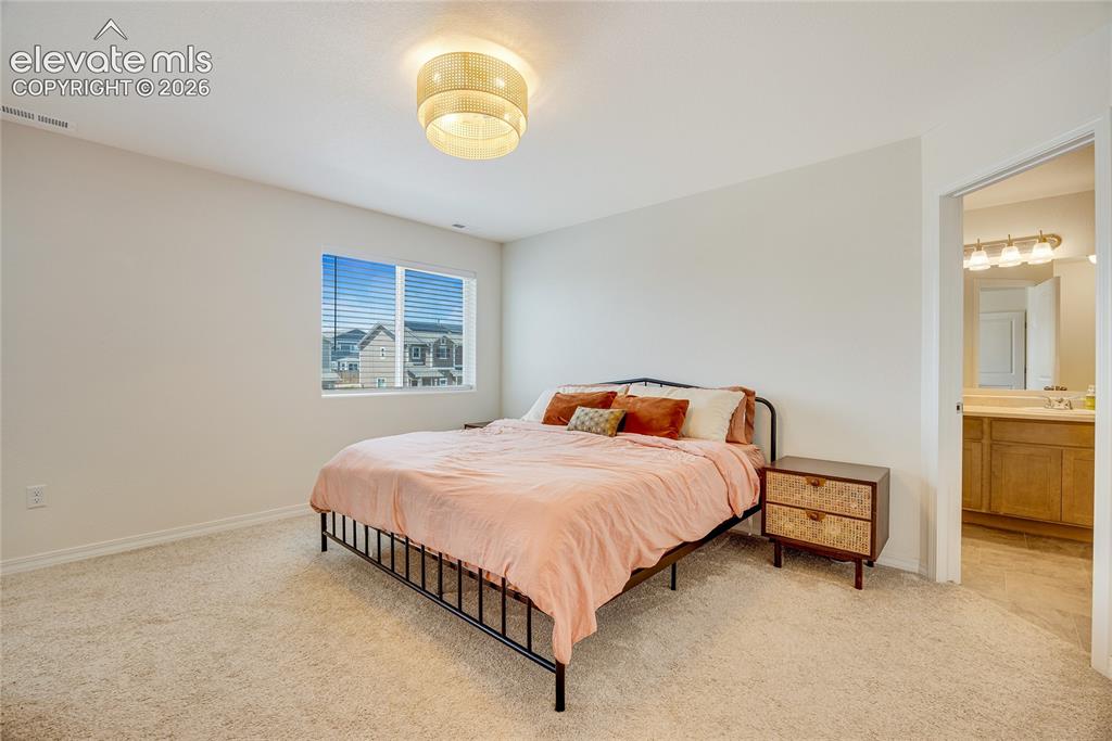 Image 17 of 42: Bedroom featuring light-toned carpeting and neutral wall paint