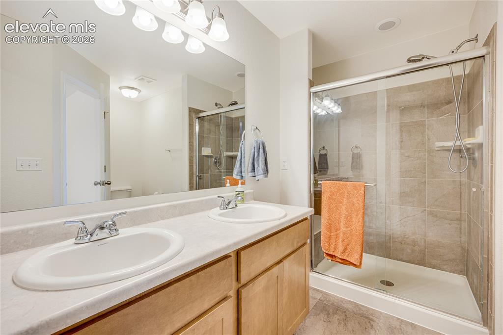 Image 20 of 42: Dual vanity with integrated sinks and chrome fixtures