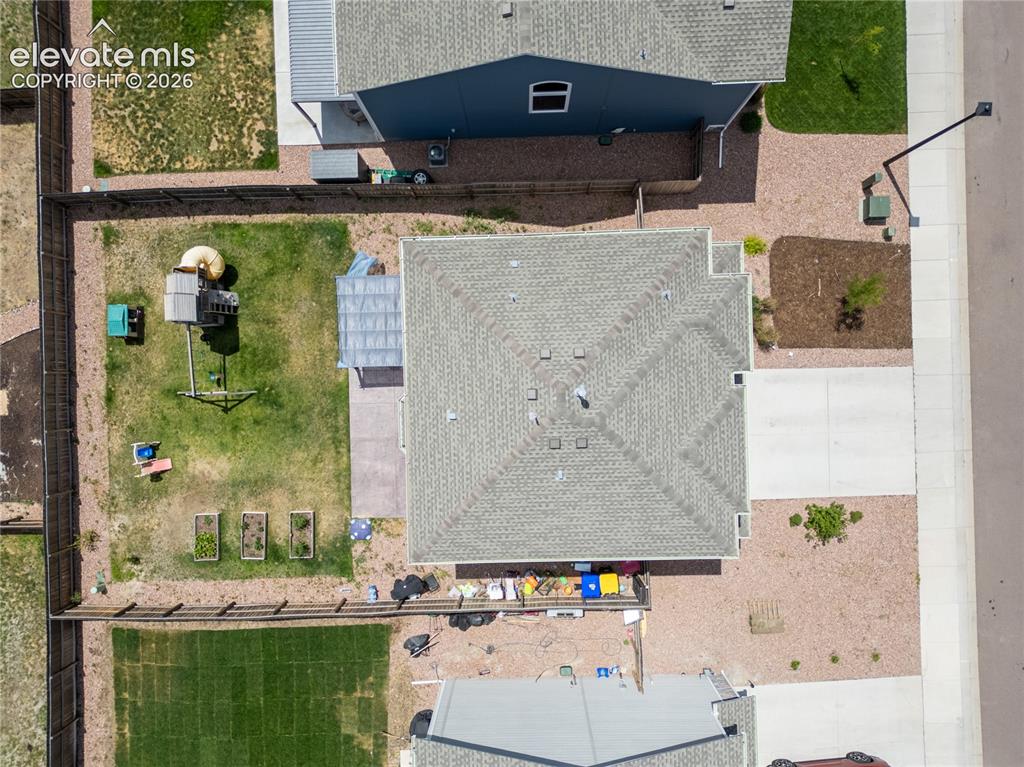 Image 29 of 42: Property featuring a shingle roof, concrete driveway, and a fenced backyard