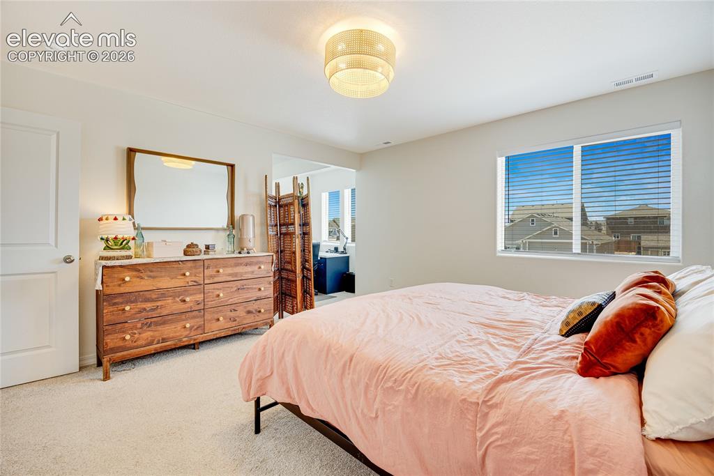 Image 7 of 42: Brightly lit room featuring neutral wall paint, light-colored carpeting, a