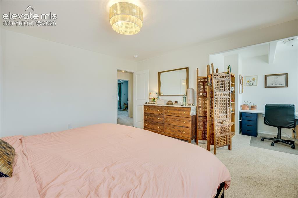 Image 8 of 42: Bedroom featuring a built-in recessed area, overhead flush mount lighting,