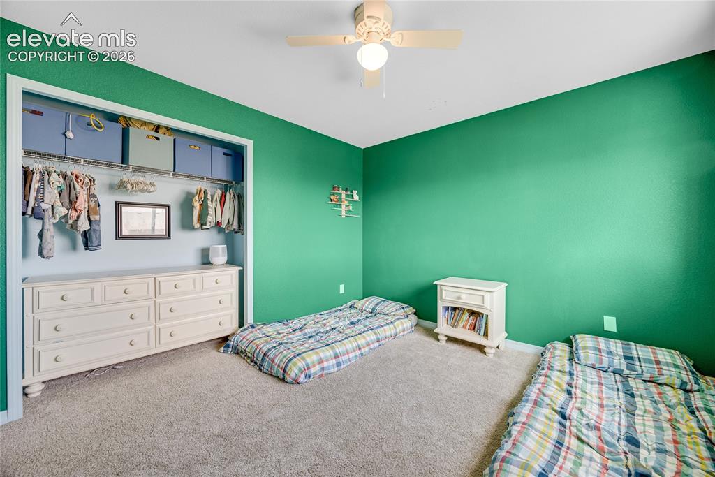 Image 9 of 42: Spacious room featuring broadloom carpeting, a built-in closet with storage