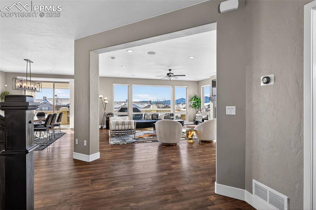 Image 10 of 50: entry leading to large family room with views of Pikes Peak