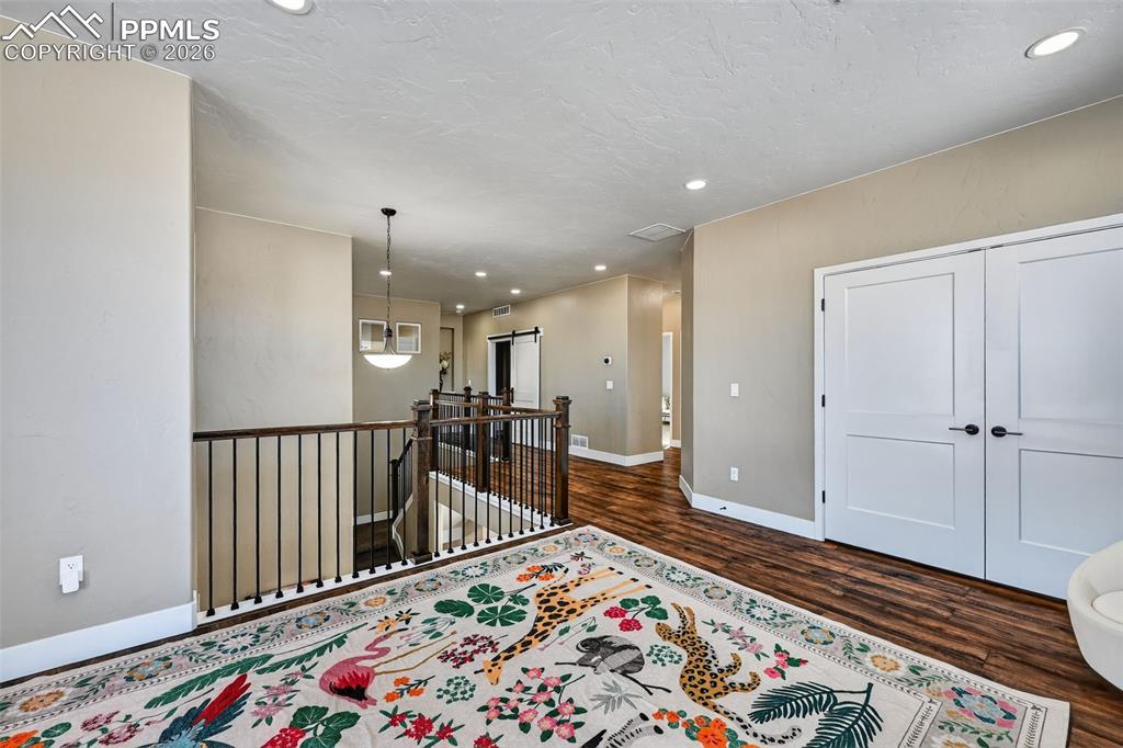 Image 25 of 50: upper level foyer with loft and plenty of storage space