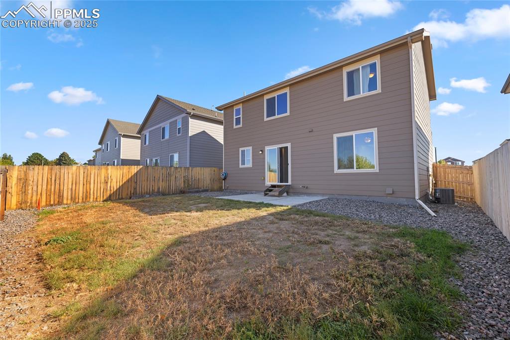 Image 14 of 24: Rear view of property with a patio area and a fenced backyard