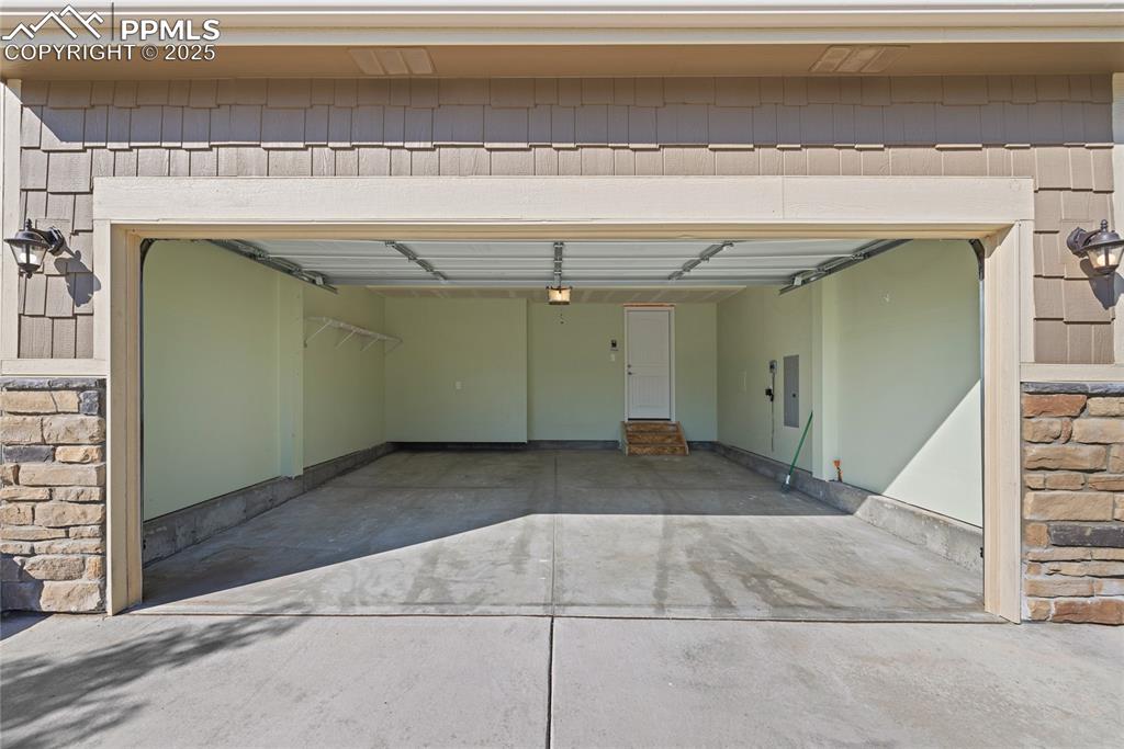 Image 5 of 24: Garage with driveway