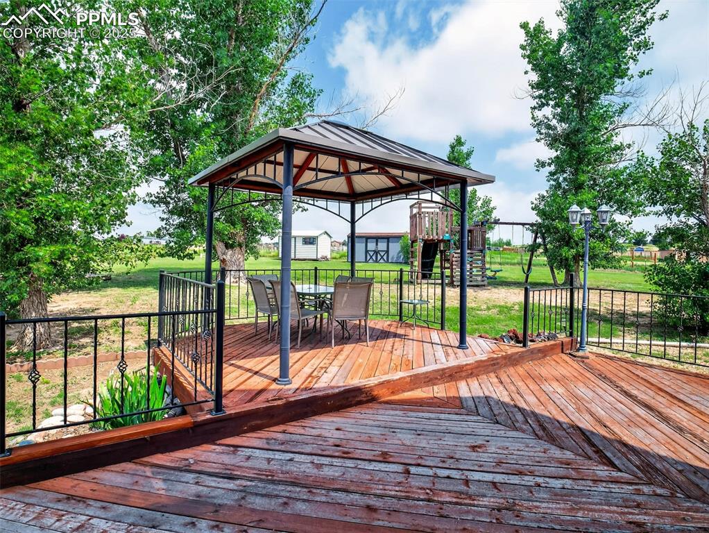 Image 10 of 45: Spacious deck with gazebo off dining room