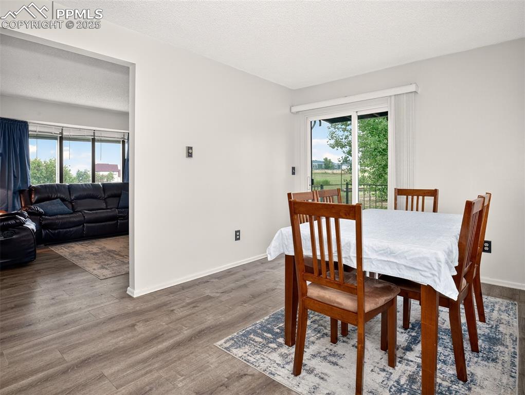 Image 11 of 45: Dining room with walk out to deck
