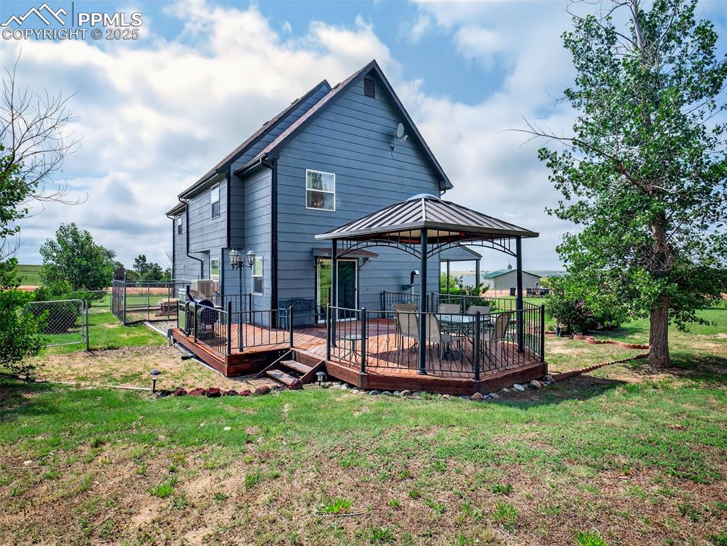 Image 38 of 45: Back of home looking to dog run and back deck