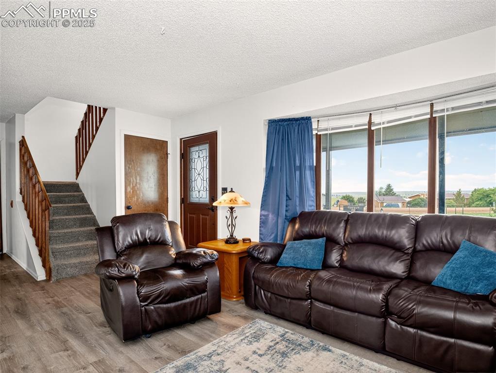 Image 5 of 45: Living room with large windows bringing in plenty of natural light!