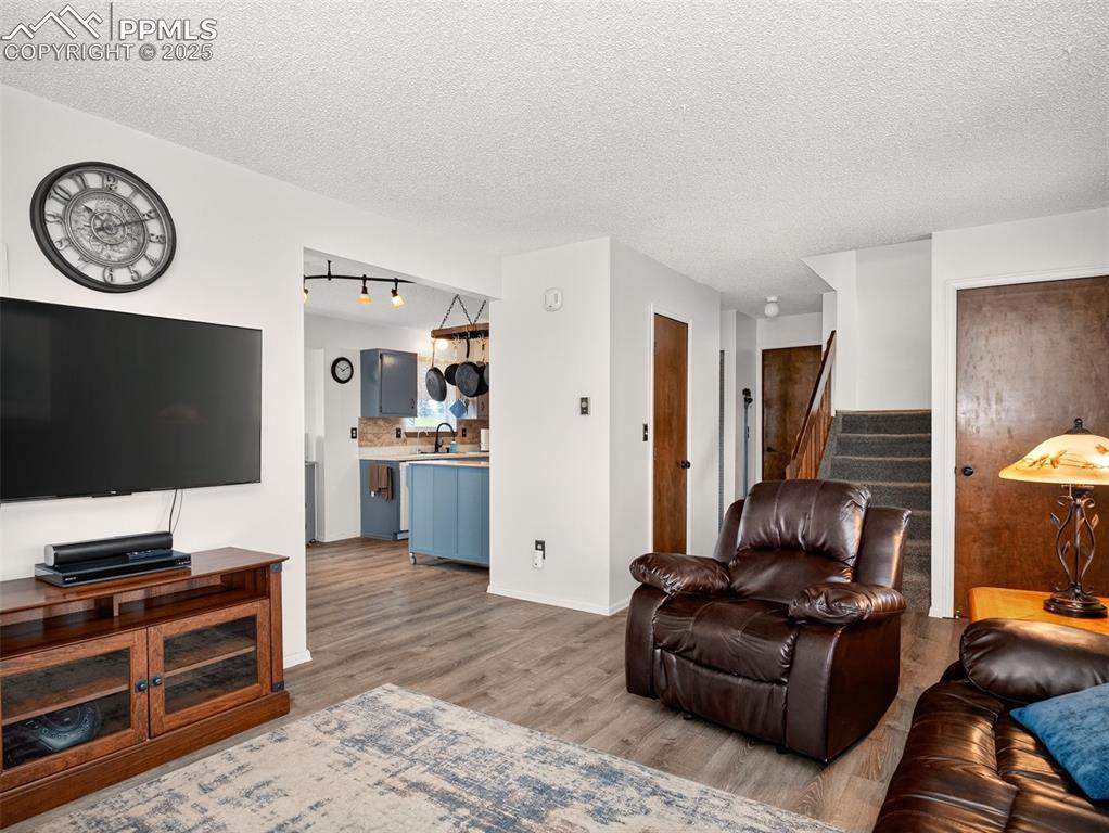 Image 6 of 45: Living room looking to kitchen and dining room