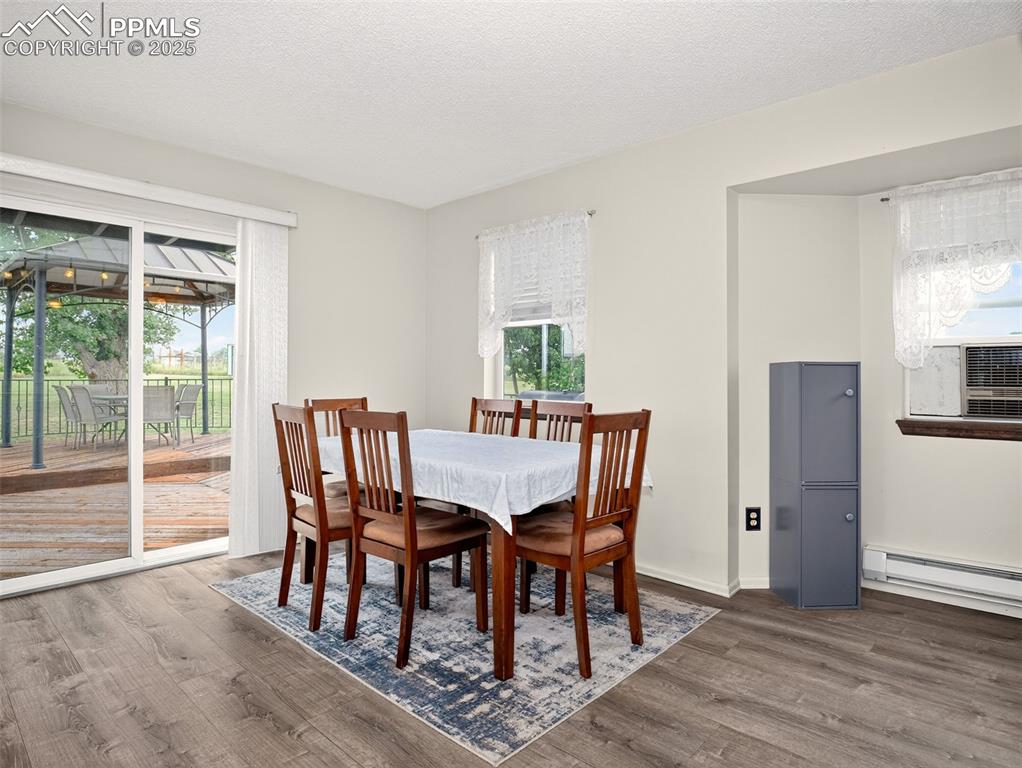 Image 9 of 45: Dining room with walk out to spacious back deck with gazebo