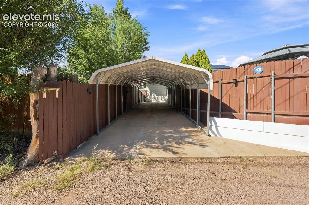 Image 41 of 42: 3 car attached carport