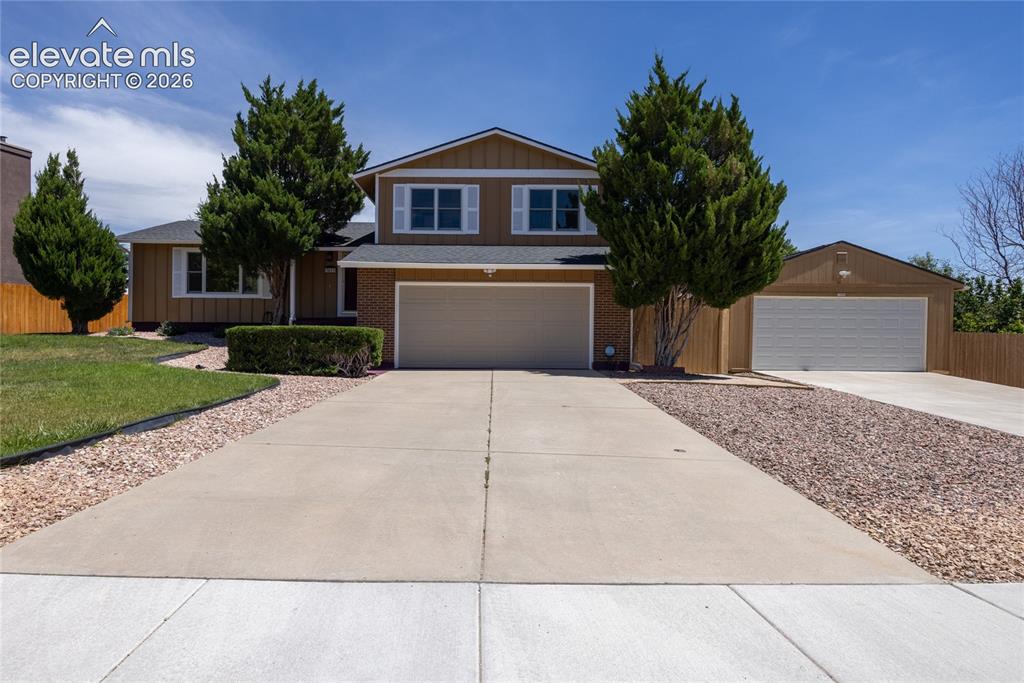 Image 1 of 46: Split-level residence featuring a two-car garage, an additional detached on