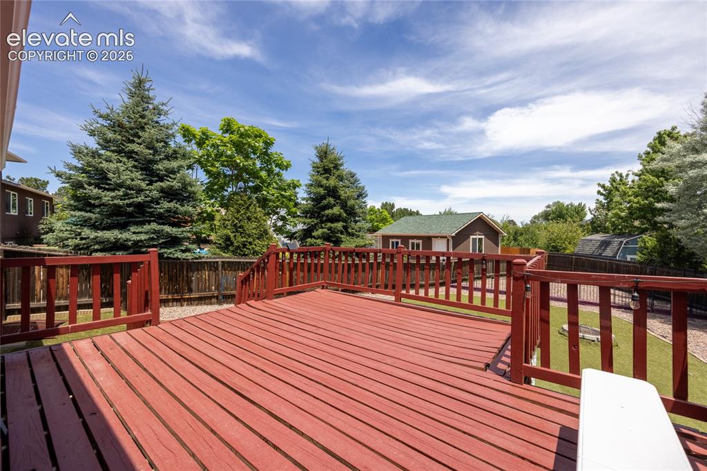 Image 33 of 46: Expansive outdoor deck featuring wood decking and matching railings