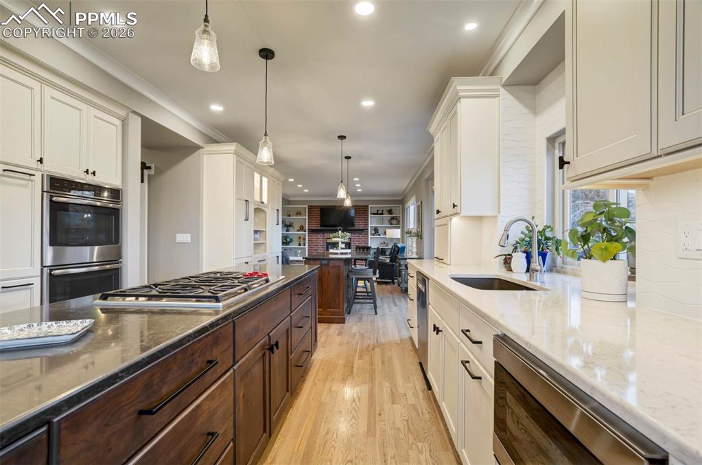 Image 12 of 50: Looking through the Kitchen to the Family Room, showing the two islands(one