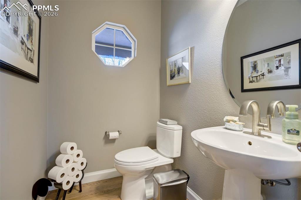 Image 18 of 50: Updated, powder room on the main floor with hardwood floors.