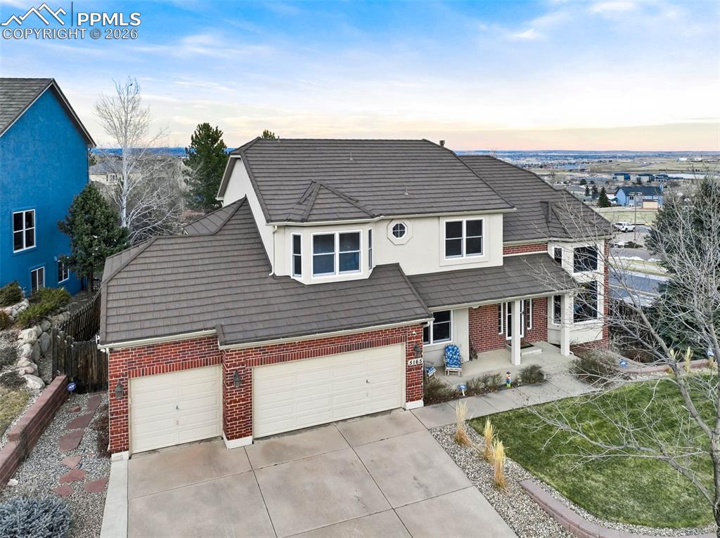 Image 2 of 50: Another aerial view of this home showing the stone coated steel roof, new w