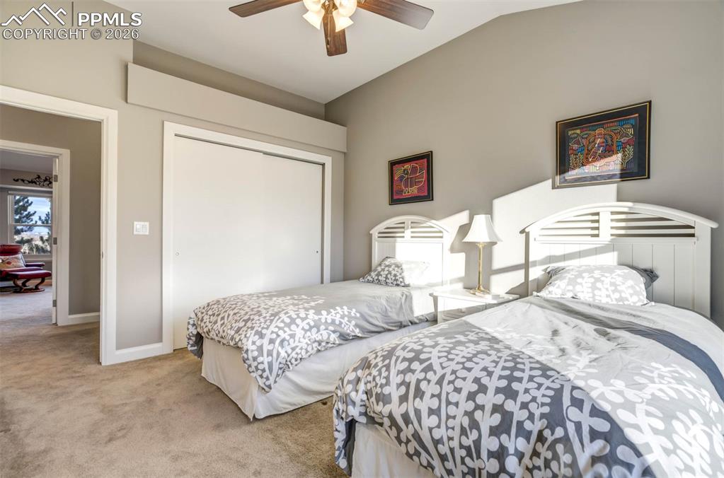 Image 27 of 50: Second view of bedroom 2 showing large closet and vaulted ceiling.