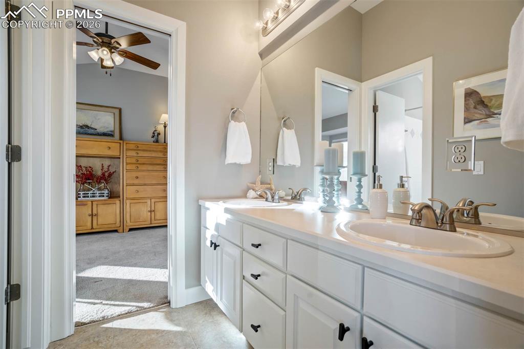 Image 30 of 50: Bathroom 3, with double vanities. Tile flooring.