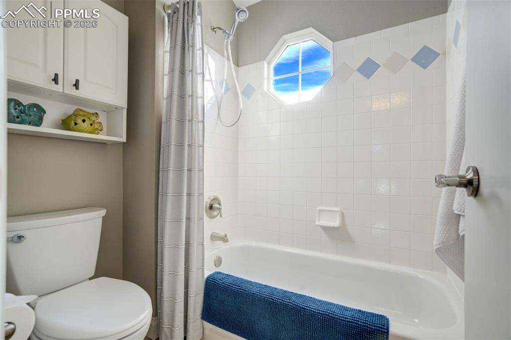 Image 31 of 50: Bathroom 3 with shower / tub combo and toilet