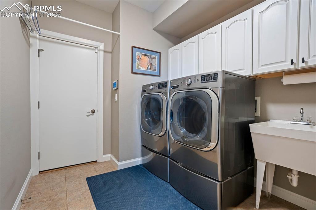 Image 44 of 50: Main floor laundry room (washer and dryer are both excluded), cabinet space