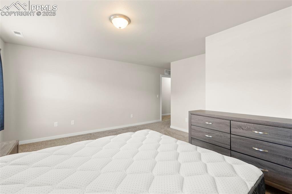 Image 17 of 27: Bedroom featuring light carpet and baseboards