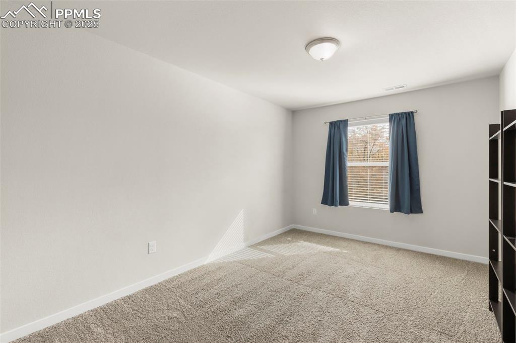 Image 21 of 27: Unfurnished room with carpet flooring