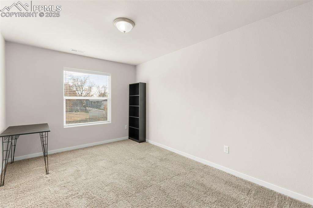 Image 23 of 27: Empty room featuring carpet and baseboards