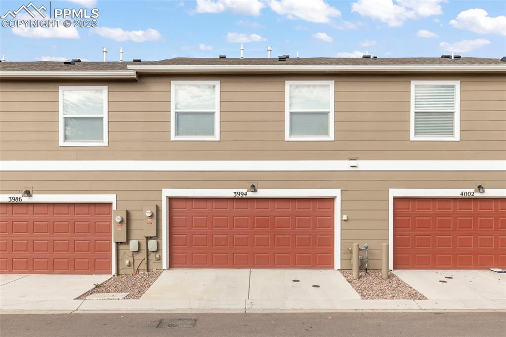 Image 26 of 27: View of front of house featuring concrete driveway and roof with shingles