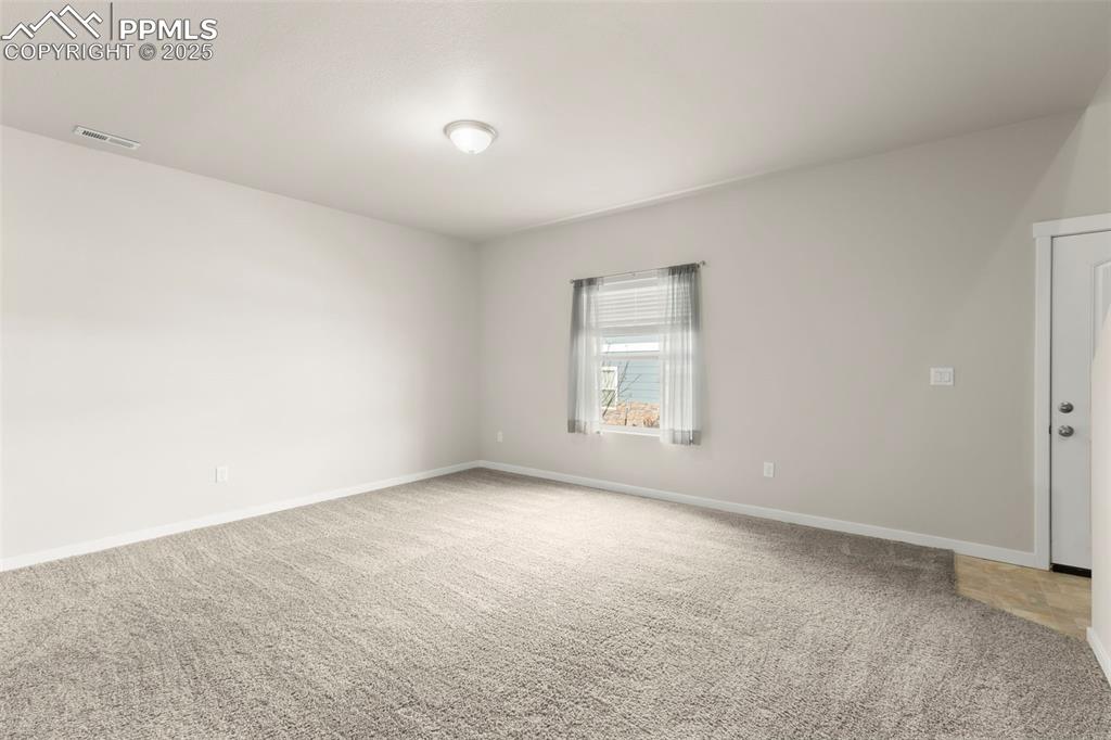Image 7 of 27: Spare room with light colored carpet and baseboards