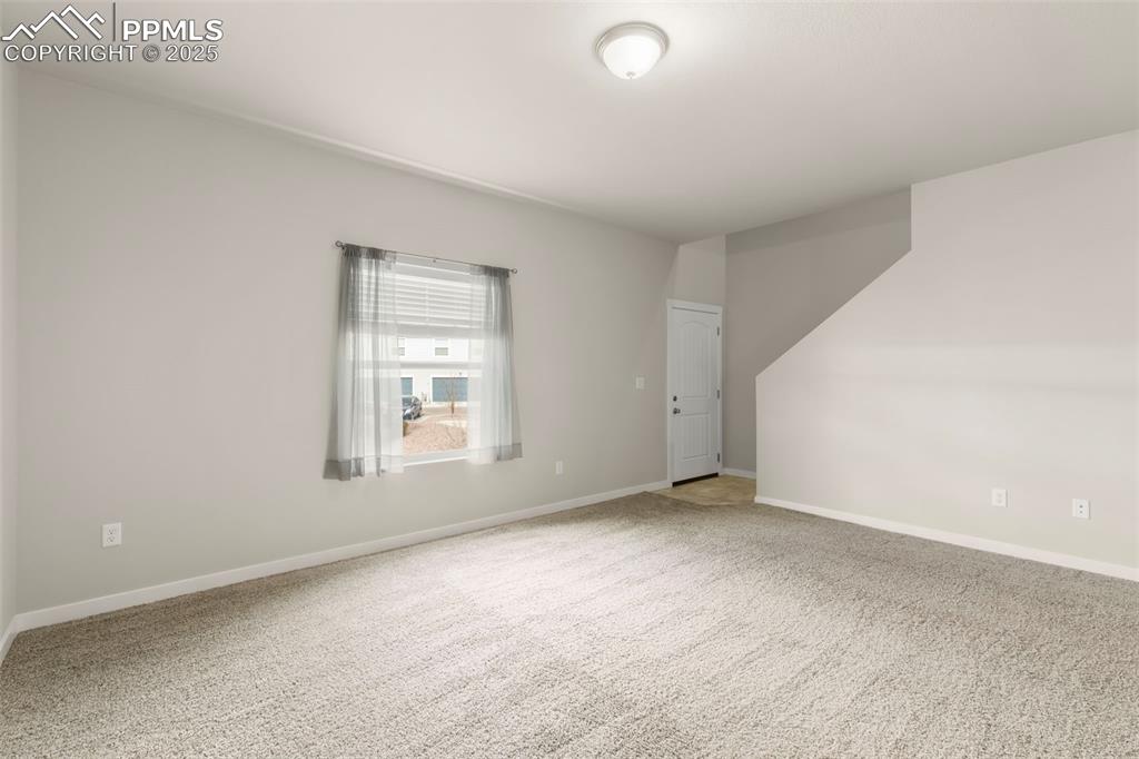 Image 8 of 27: Carpeted empty room with baseboards
