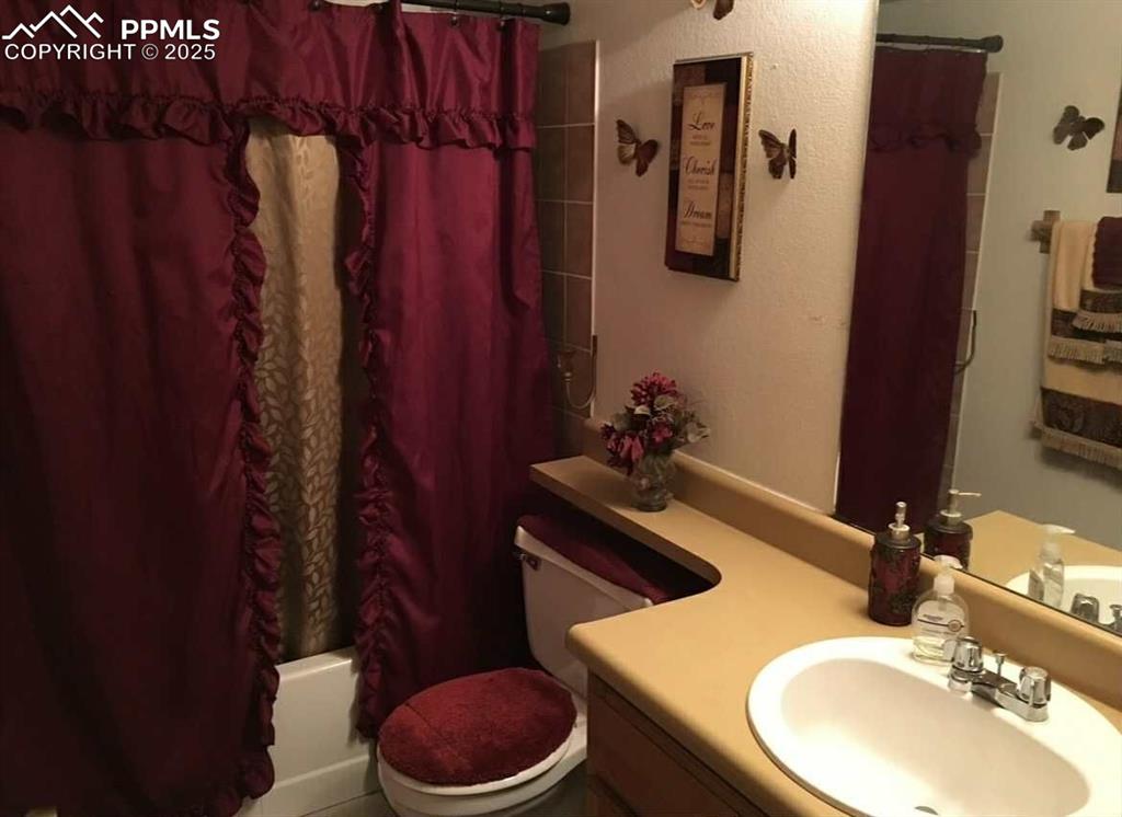 Image 17 of 20: Bathroom featuring vanity and shower / tub combo with curtain