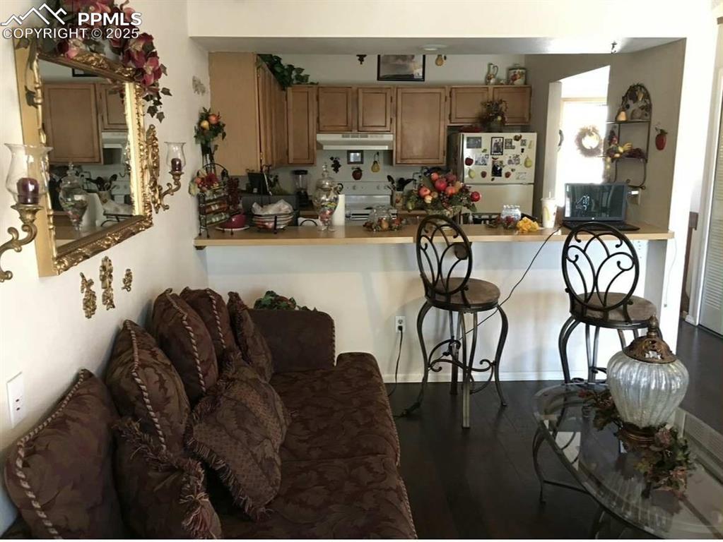 Image 3 of 20: Kitchen featuring freestanding refrigerator, dark wood-style flooring, a ki