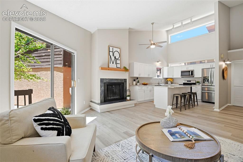 Image 4 of 19: Open-concept living space with vaulted ceilings