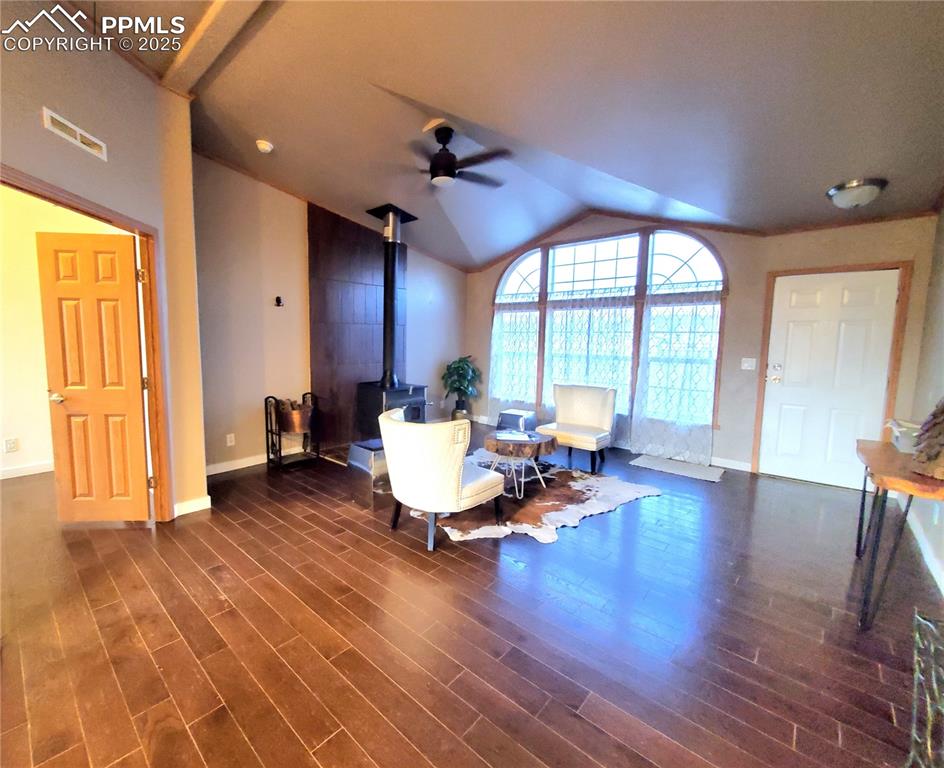 Image 10 of 50: Cathedral windows let the natural lighting cascade into the home while the 