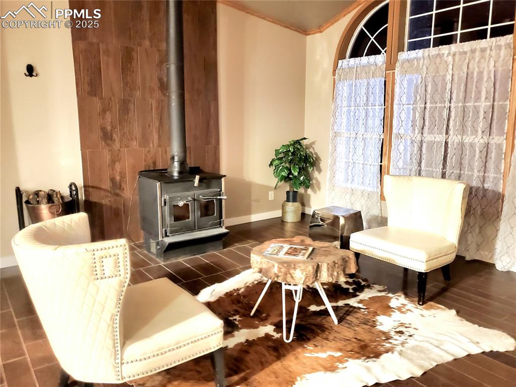 Image 12 of 50: Enter here in the formal living room with wonderful freedom woodstove which