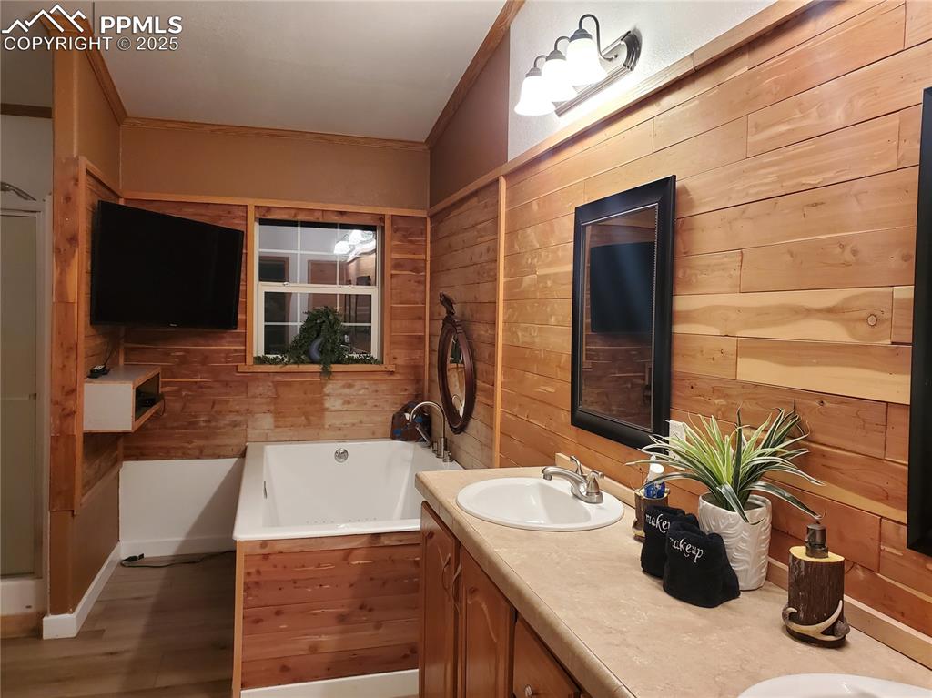 Image 18 of 50: Master bath large jacuzzi tub, shower, double sinks and has plentiful warm 